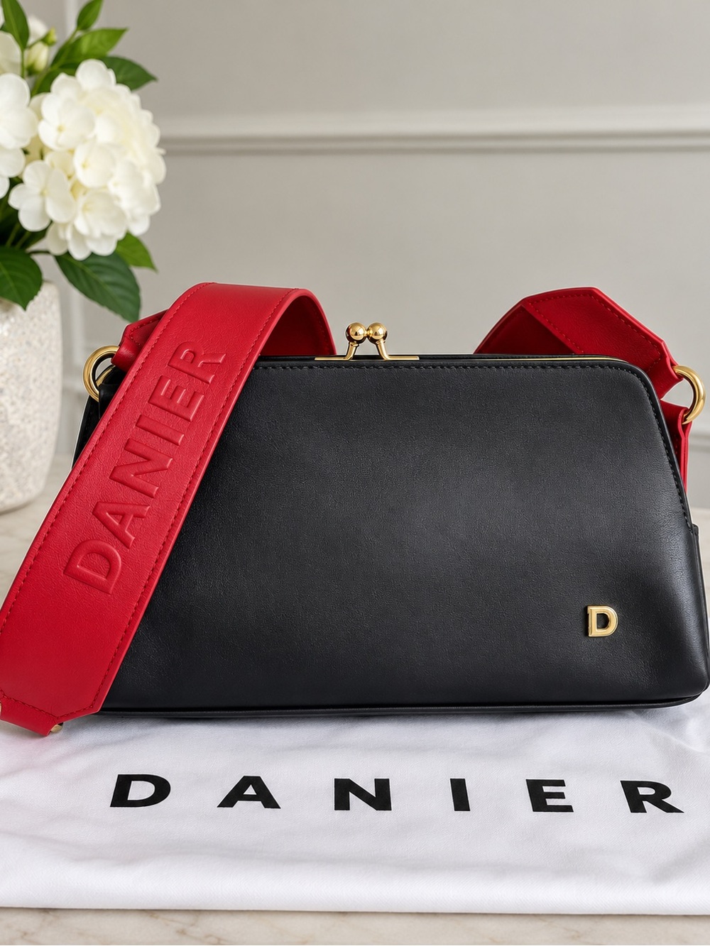 Danier Black Leather Kiss Lock Bag Red Logo Strap